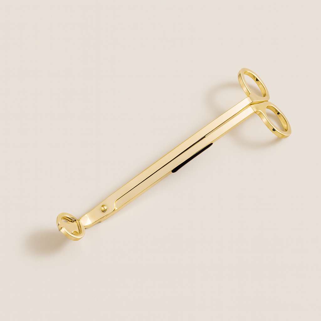 Gold candle wick trimmer with sleek polished finish for candle care