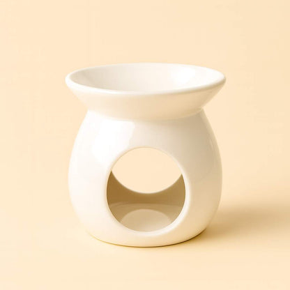 White ceramic oil burner on a beige background by Scent 26
