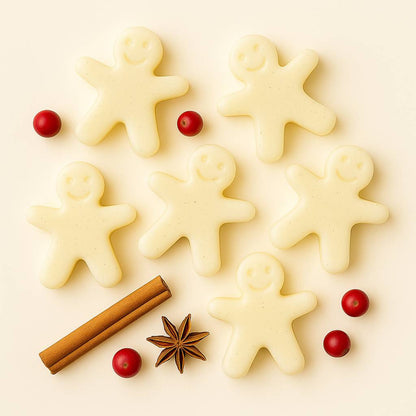 Six gingerbread men shaped wax melts on an off-white background by Scent 26