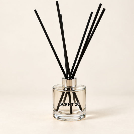 Scent 26 Lemongrass + Ginger Reed Diffuser in a stylish glass bottle with black reeds. A handmade UK home fragrance featuring fresh, zesty lemongrass and warm, spicy ginger notes, designed to bring an uplifting scent to any room.