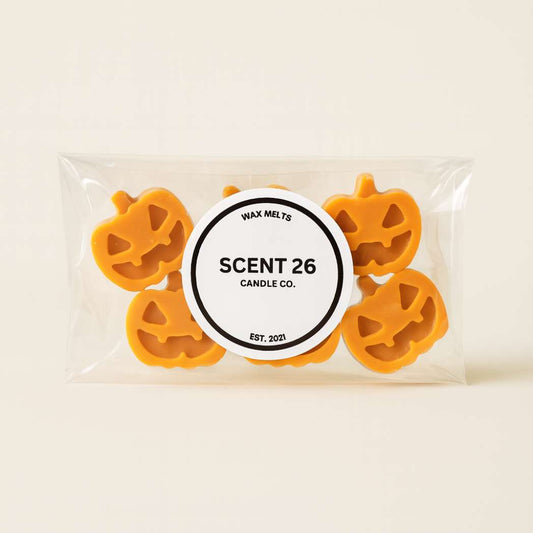 Scent 26 Pumpkin Spice Wax Melts shaped like pumpkins on marble background