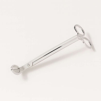 Silver candle wick trimmer on neutral background, luxury candle accessory
