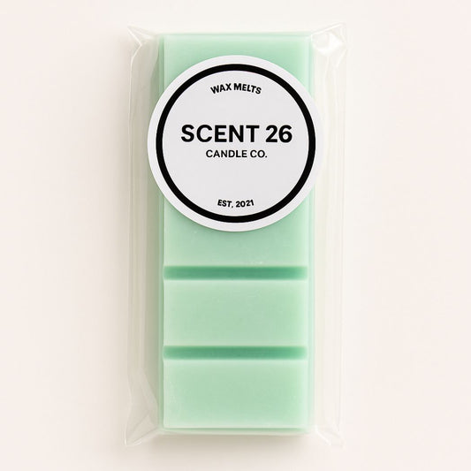 A mint green Lenor Rose Spring Awakening wax melt bar in a clear plastic bag with a white circular label that reads 'SCENT 26 CANDLE CO.' on a light beige background.
