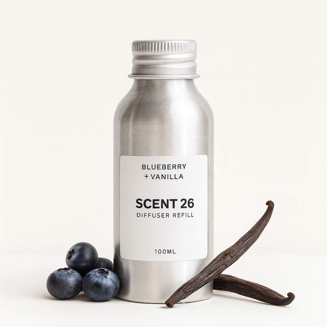 Scent 26 Blueberry + Vanilla diffuser refill 100ml bottle styled with blueberries and vanilla pods, illustrating a creamy sweet gourmand fragrance in a minimalist product scene.